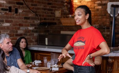 a tour guide leading a pizza tour